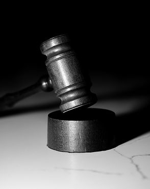 A judge's gavel resting on its sound block.